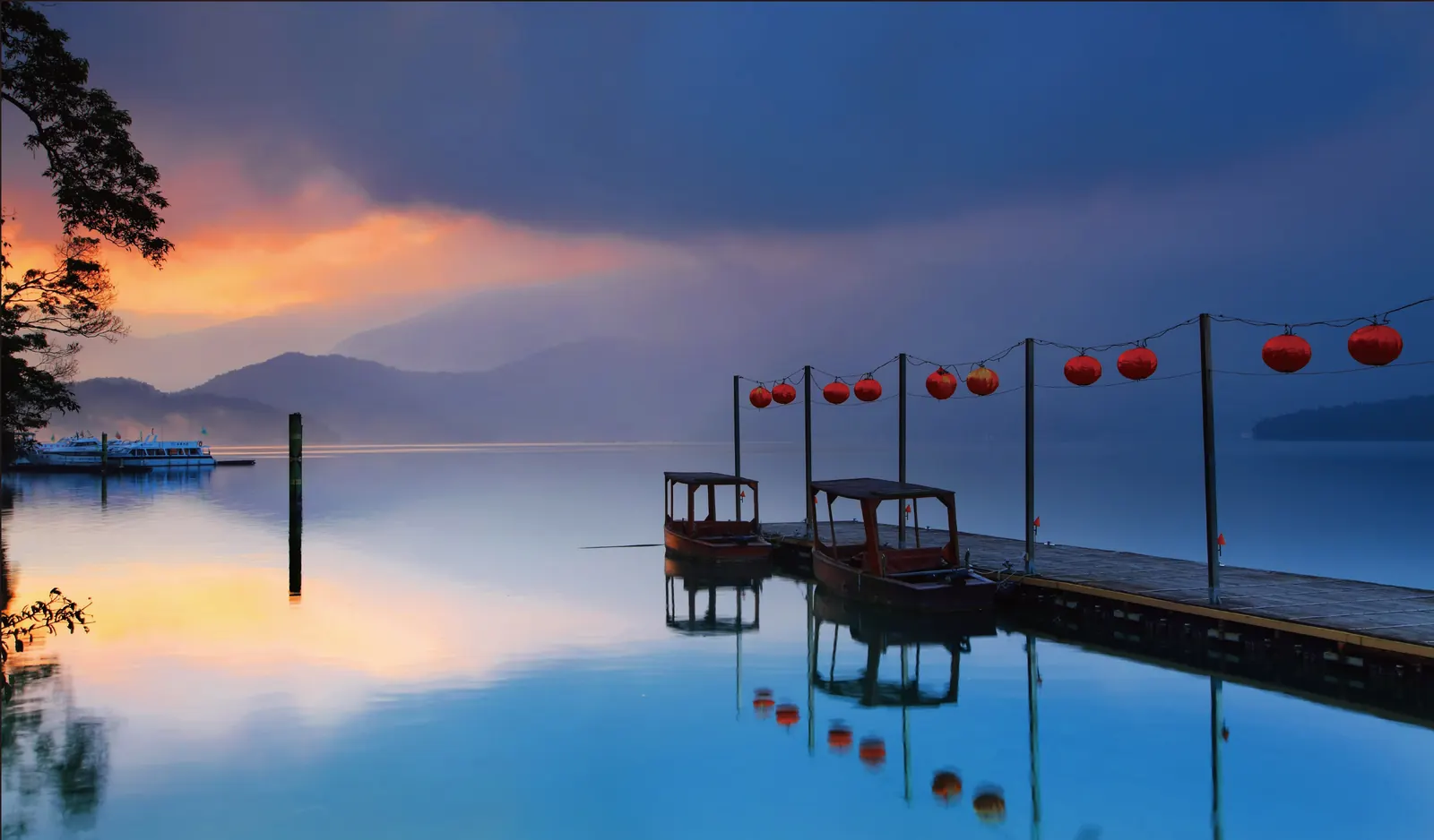Sun Moon Lake at dawn, lanterns along the pier